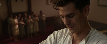 Movie still from “Hacksaw Ridge” (2016), directed by Mel Gibson – A person wearing a white shirt; Close Up shot, Over the shoulder angle