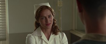 Movie still from “Hacksaw Ridge” (2016), directed by Mel Gibson – A woman wearing a nurse's uniform in front of a hospital bed; Close Up shot, Over the shoulder angle