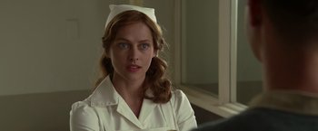 Movie still from “Hacksaw Ridge” (2016), directed by Mel Gibson – A woman in a nurse's uniform with a hat on her head; Close Up shot, Over the shoulder angle
