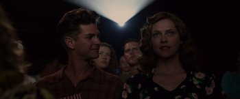 Movie still from “Hacksaw Ridge” (2016), directed by Mel Gibson – A man and a woman standing next to each other in front of a projector; Close Up shot, Low angle