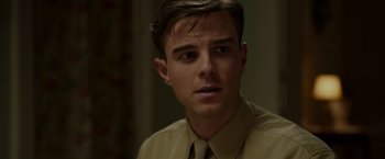 Movie still from “Hacksaw Ridge” (2016), directed by Mel Gibson – A man in a tan shirt and a brown tie; Close Up shot, Over the shoulder angle