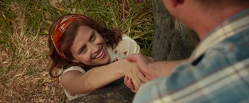 Movie still from “Hacksaw Ridge” (2016), directed by Mel Gibson – A young woman is smiling while holding a man's hand; Close Up shot, Over the shoulder angle