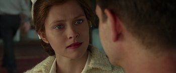 Movie still from “Hacksaw Ridge” (2016), directed by Mel Gibson – A young woman looking at a man in the mirror; Close Up shot, Over the shoulder angle