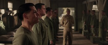 Movie still from “Hacksaw Ridge” (2016), directed by Mel Gibson – A group of men standing next to each other; Medium shot, Over the shoulder angle