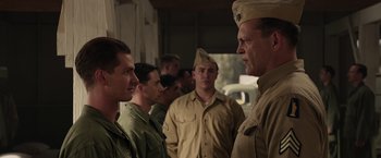 Movie still from “Hacksaw Ridge” (2016), directed by Mel Gibson – A group of men standing next to each other in uniform; Medium shot, Over the shoulder angle