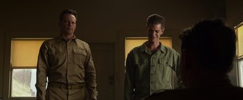 Movie still from “Hacksaw Ridge” (2016), directed by Mel Gibson – Two men standing next to each other in a room; Medium shot, Over the shoulder angle