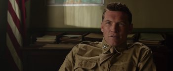 Movie still from “Hacksaw Ridge” (2016), directed by Mel Gibson – A person wearing a military uniform; Close Up shot, Over the shoulder angle