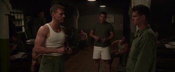 Movie still from “Hacksaw Ridge” (2016), directed by Mel Gibson – A group of men standing around in a room; Medium shot, Over the shoulder angle