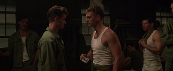 Movie still from “Hacksaw Ridge” (2016), directed by Mel Gibson – Two young men standing next to each other in a room; Medium shot, Over the shoulder angle