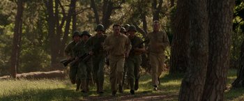 Movie still from “Hacksaw Ridge” (2016), directed by Mel Gibson – A group of men are running in the woods; Wide shot, High angle
