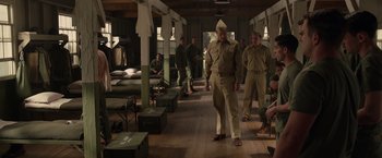 Movie still from “Hacksaw Ridge” (2016), directed by Mel Gibson – A group of men standing in a room with boxes; Wide shot, High angle