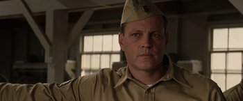 Movie still from “Hacksaw Ridge” (2016), directed by Mel Gibson – A person wearing a uniform; Close Up shot, Low angle