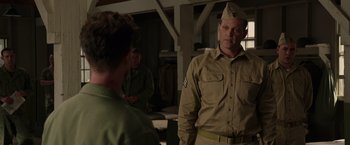 Movie still from “Hacksaw Ridge” (2016), directed by Mel Gibson – A man in a uniform talking to another man in a uniform; Medium shot, Over the shoulder angle