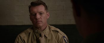 Movie still from “Hacksaw Ridge” (2016), directed by Mel Gibson – A person wearing a uniform; Close Up shot, Over the shoulder angle