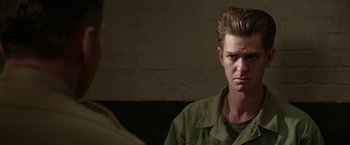 Movie still from “Hacksaw Ridge” (2016), directed by Mel Gibson – A man in a green shirt is talking to another man in a green shirt; Close Up shot, Over the shoulder angle