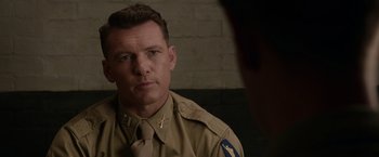 Movie still from “Hacksaw Ridge” (2016), directed by Mel Gibson – A person wearing a uniform; Close Up shot, Over the shoulder angle