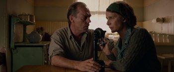 Movie still from “Hacksaw Ridge” (2016), directed by Mel Gibson – A man and a woman sitting in front of a video camera; Close Up shot, Low angle