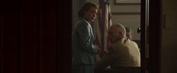Movie still from “Hacksaw Ridge” (2016), directed by Mel Gibson – A man and a woman standing next to each other in front of an american flag; Medium shot, Low angle