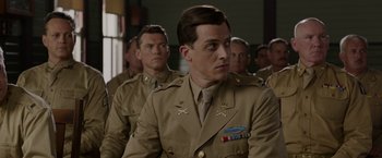Movie still from “Hacksaw Ridge” (2016), directed by Mel Gibson – A group of men in military uniforms in a room; Medium shot, Over the shoulder angle