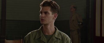Movie still from “Hacksaw Ridge” (2016), directed by Mel Gibson – A young man in a military uniform looking to his left; Close Up shot, Low angle