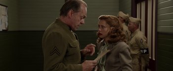 Movie still from “Hacksaw Ridge” (2016), directed by Mel Gibson – An older man and a young woman in a room; Medium shot, Over the shoulder angle