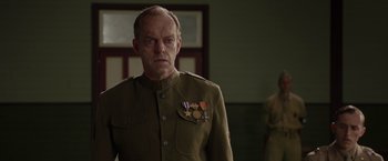 Movie still from “Hacksaw Ridge” (2016), directed by Mel Gibson – A man in a military uniform with medals on his chest; Close Up shot, Low angle