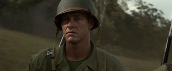 Movie still from “Hacksaw Ridge” (2016), directed by Mel Gibson – A man in a military uniform wearing a helmet; Close Up shot, Over the shoulder angle