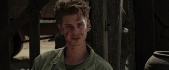 Movie still from “Hacksaw Ridge” (2016), directed by Mel Gibson – A young man with dirt all over his face; Close Up shot, Over the shoulder angle