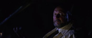 Movie still from “Halloween” (1978), directed by John Carpenter – A man with a beard wearing a white shirt and a tie; Close Up shot, Low angle