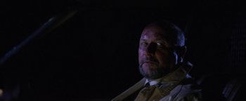 Movie still from “Halloween” (1978), directed by John Carpenter – A man with a beard wearing a suit and tie; Close Up shot, Low angle
