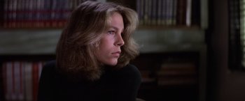 Movie still from “Halloween” (1978), directed by John Carpenter – A woman with long brown hair sitting in a room; Close Up shot, Low angle