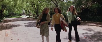 Movie still from “Halloween” (1978), directed by John Carpenter – A group of women walking down a sidewalk holding shopping bags; Wide shot, Low angle