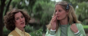 Movie still from “Halloween” (1978), directed by John Carpenter – A woman smoking a cigarette while talking to another woman; Close Up shot, Low angle