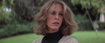Movie still from “Halloween” (1978), directed by John Carpenter – A person wearing a sweater; Close Up shot, Low angle