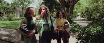 Movie still from “Halloween” (1978), directed by John Carpenter – A group of women standing next to each other on a sidewalk; Medium shot, Low angle