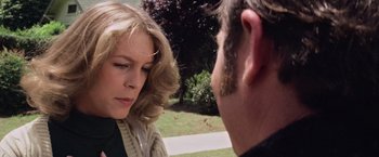 Movie still from “Halloween” (1978), directed by John Carpenter – A man and a woman talking to each other outside; Close Up shot, Over the shoulder angle