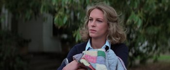 Movie still from “Halloween” (1978), directed by John Carpenter – A woman holding a quilt in her arms; Close Up shot, Low angle