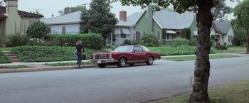 Movie still from “Halloween” (1978), directed by John Carpenter – An older car parked on the side of the street; Wide shot, Low angle