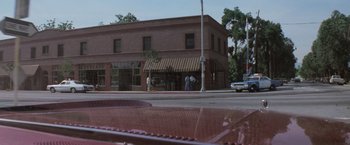 Movie still from “Halloween” (1978), directed by John Carpenter – Two people standing on the side of the street; Extreme Wide shot, High angle