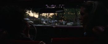 Movie still from “Halloween” (1978), directed by John Carpenter – A view from inside a car looking out the window; Wide shot, Low angle