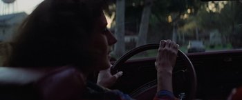 Movie still from “Halloween” (1978), directed by John Carpenter – A person sitting in the drivers seat of a car; Close Up shot, Over the shoulder angle