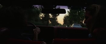 Movie still from “Halloween” (1978), directed by John Carpenter – A person driving a car in the dark; Wide shot, High angle