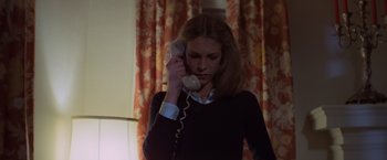 Movie still from “Halloween” (1978), directed by John Carpenter – A woman holding a phone up to her ear; Medium shot, Low angle