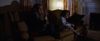 Movie still from “Halloween” (1978), directed by John Carpenter – Two children sitting on a couch watching television; Medium shot, Low angle