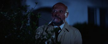 Movie still from “Halloween” (1978), directed by John Carpenter – A man with a goatee smoking a cigarette; Close Up shot, Low angle