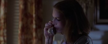 Movie still from “Halloween” (1978), directed by John Carpenter – A woman is talking on a phone in the dark; Close Up shot, Low angle