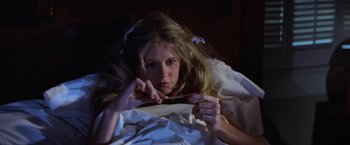 Movie still from “Halloween” (1978), directed by John Carpenter – A young girl laying in a bed with a white sheet; Close Up shot, High angle