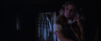Movie still from “Halloween” (1978), directed by John Carpenter – A woman holding a phone in a dark room; Close Up shot, Low angle