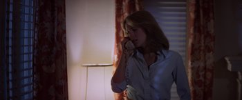 Movie still from “Halloween” (1978), directed by John Carpenter – A woman talking on a phone in a room; Medium shot, Low angle
