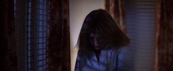 Movie still from “Halloween” (1978), directed by John Carpenter – A woman with long dark hair is holding a phone; Close Up shot, High angle
